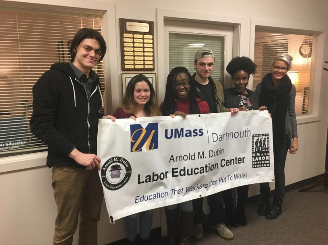 Interns holding a banner
