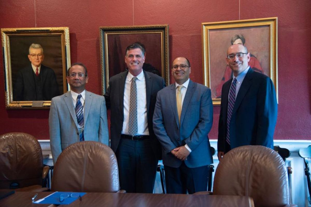 Administrators posing after signing contract