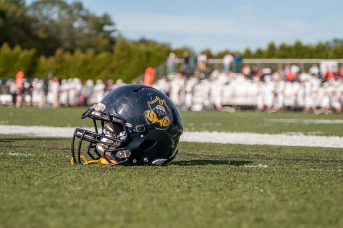 Football helmet sitting on a football field