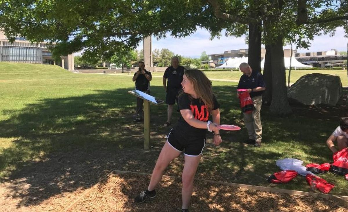 Student playing disc golf