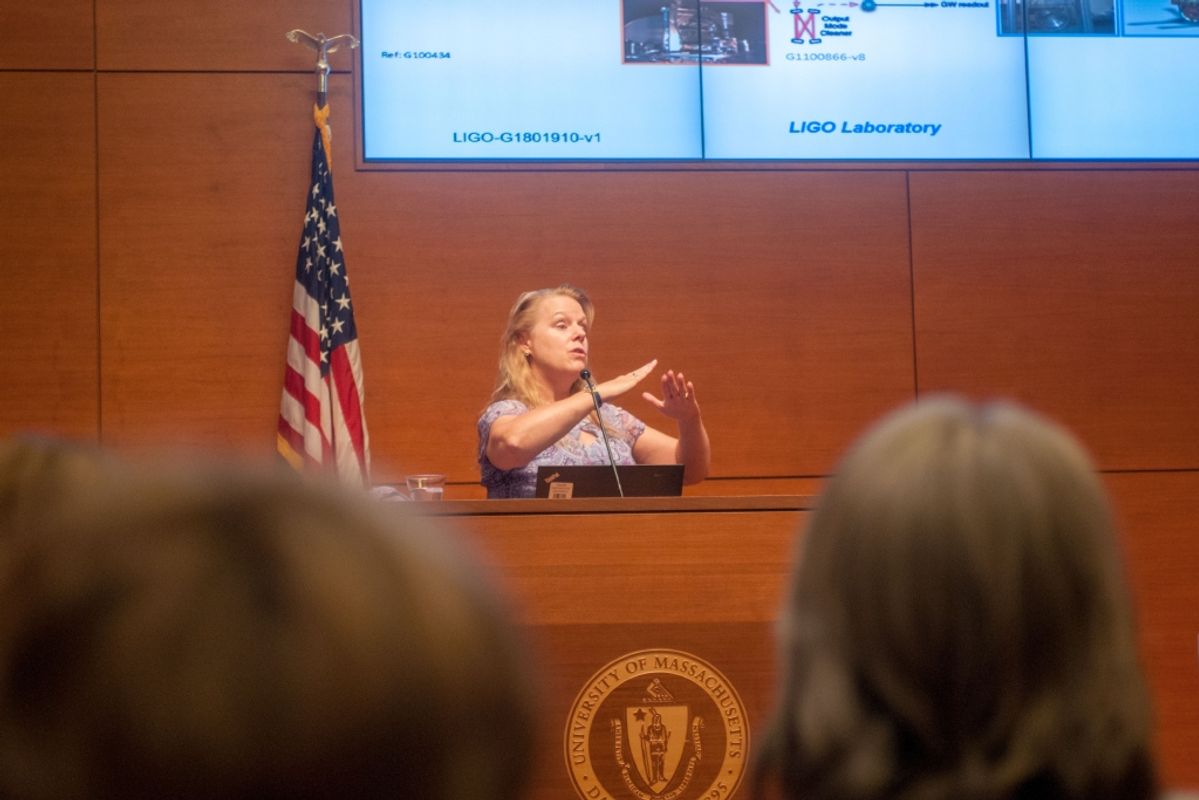 LIGO engineer Janeen Romie '83 speaking at podium in Grand Reading Room at Claire T. Carney Library