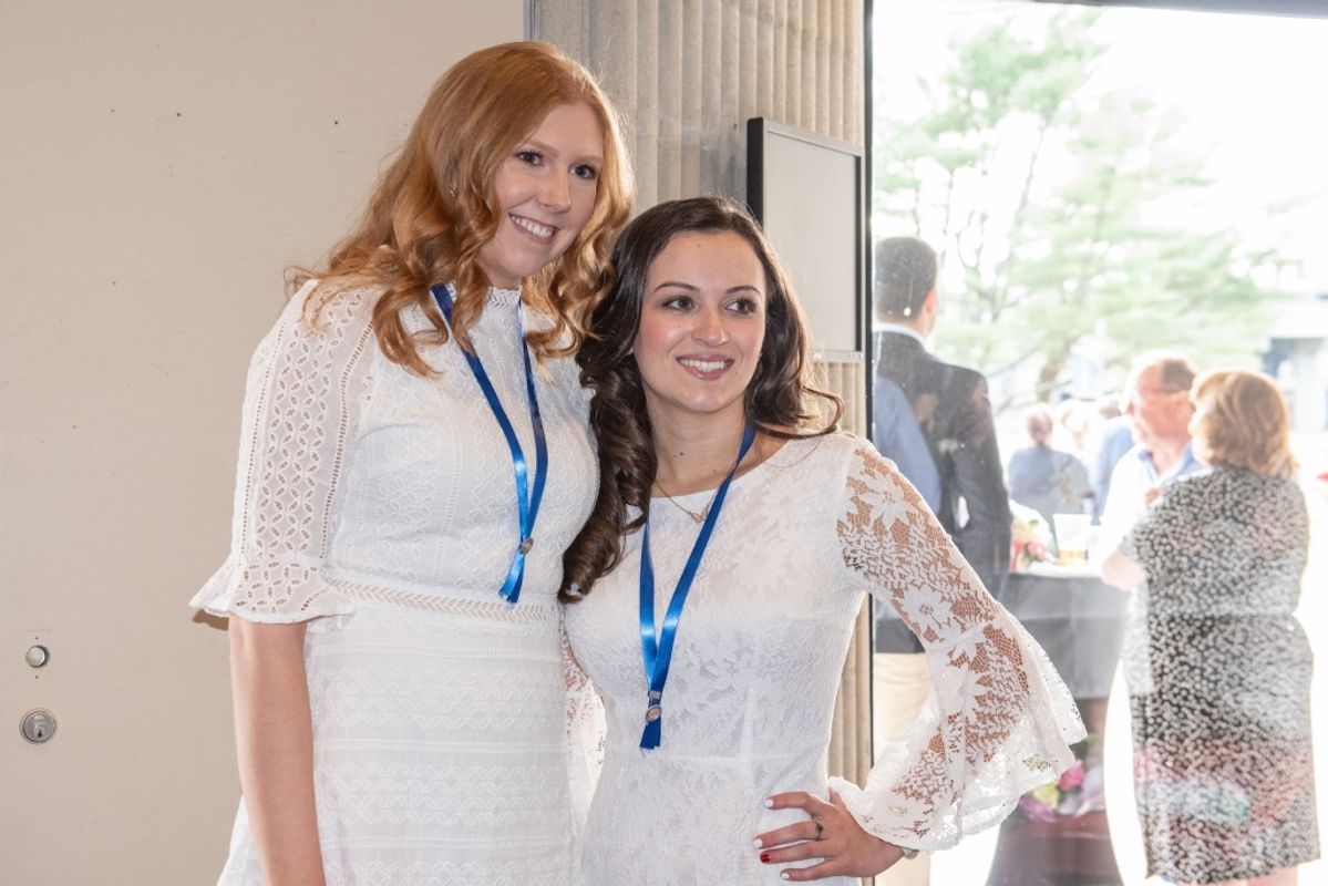 Nursing graduates Alexandra Neronah and Samantha Silveira following the ceremony