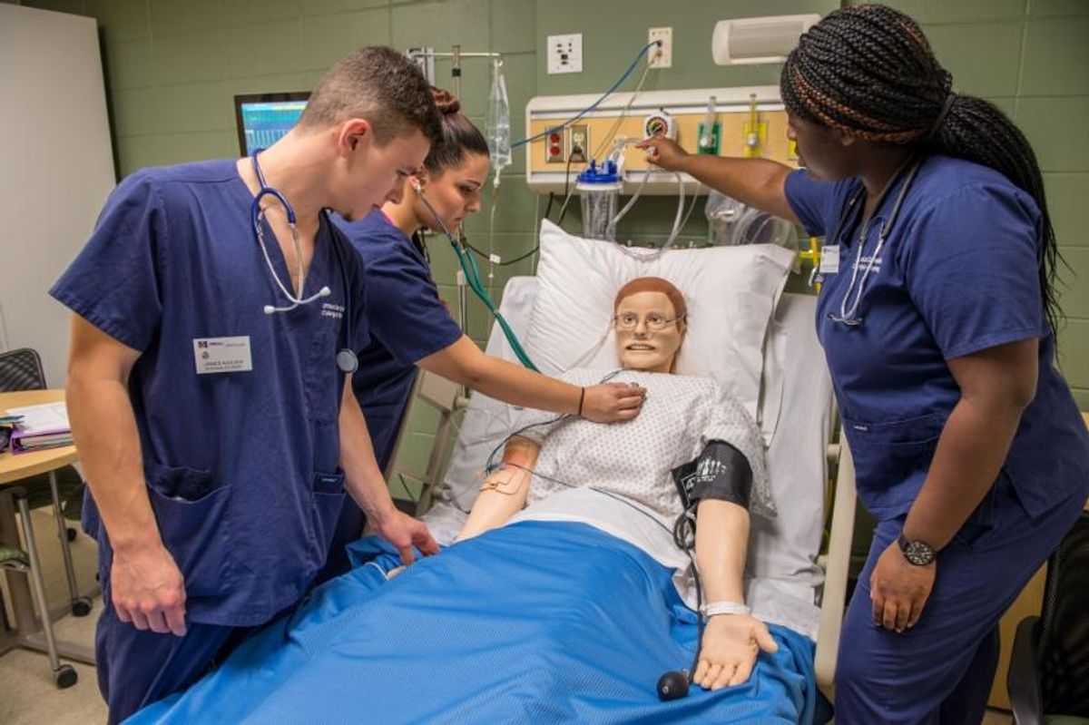 Nursing students practice taking vitals in the Sim Lab