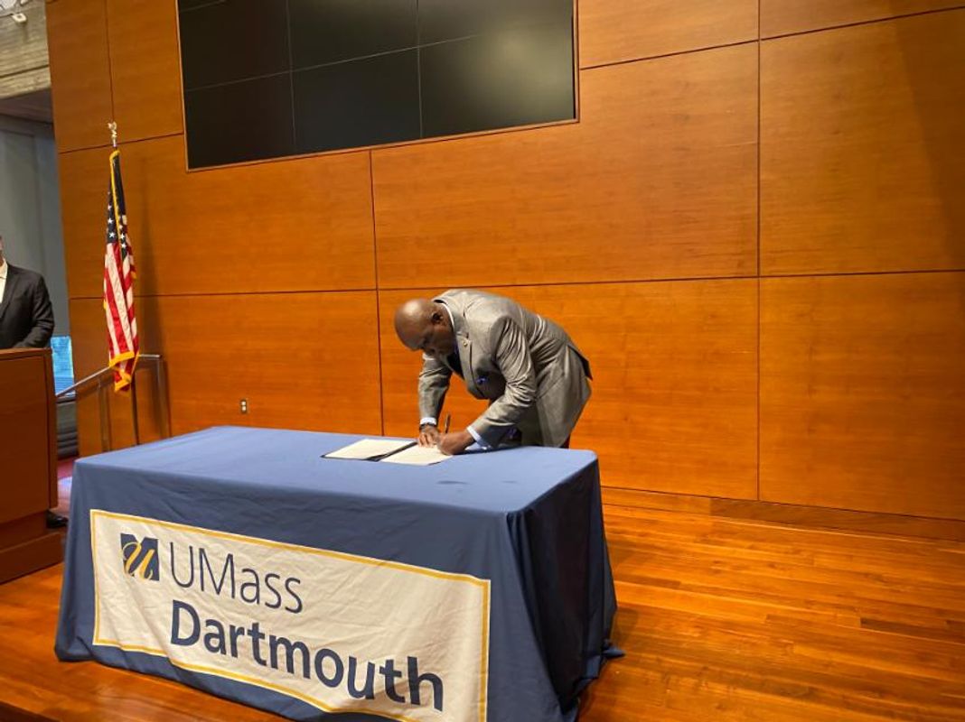 Chancellor Johnson signing Carbon Commitment document
