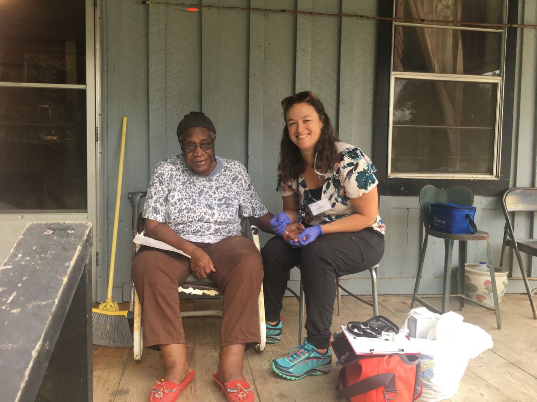 UMass Dartmouth nursing student with female patient on porch in Glendora, MS
