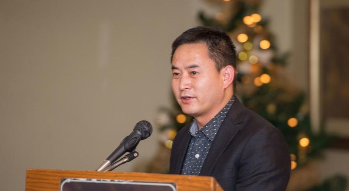 Honggang Wang speaking at lecturn