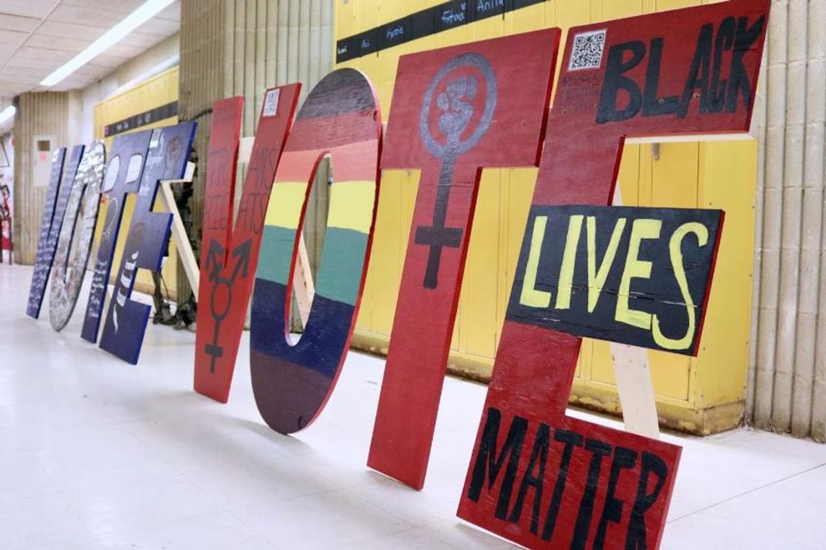 Student made V-O-T-E signs