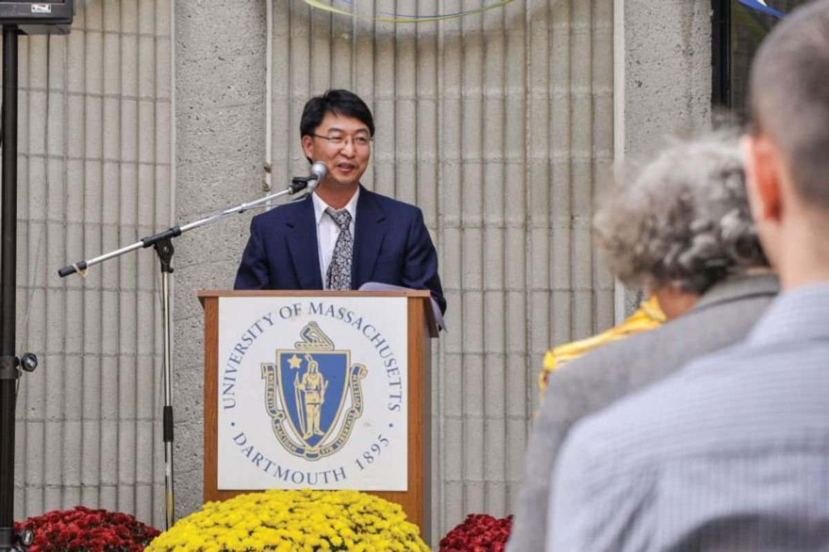Professor Maolin Guo standing at lectern