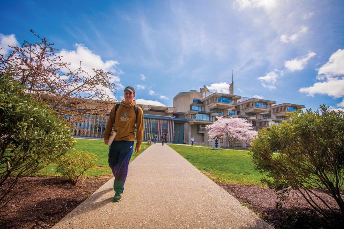 Student walking on campus in spring