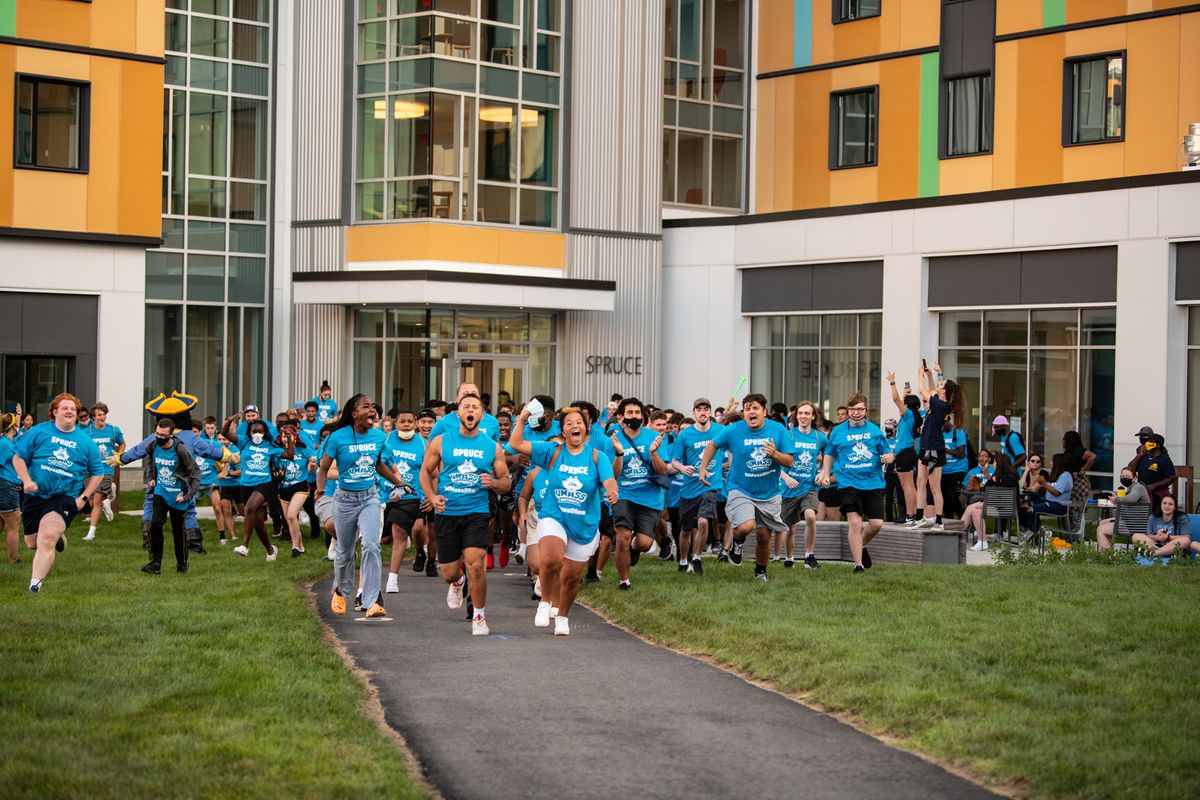 Students playing cornhole on the quad