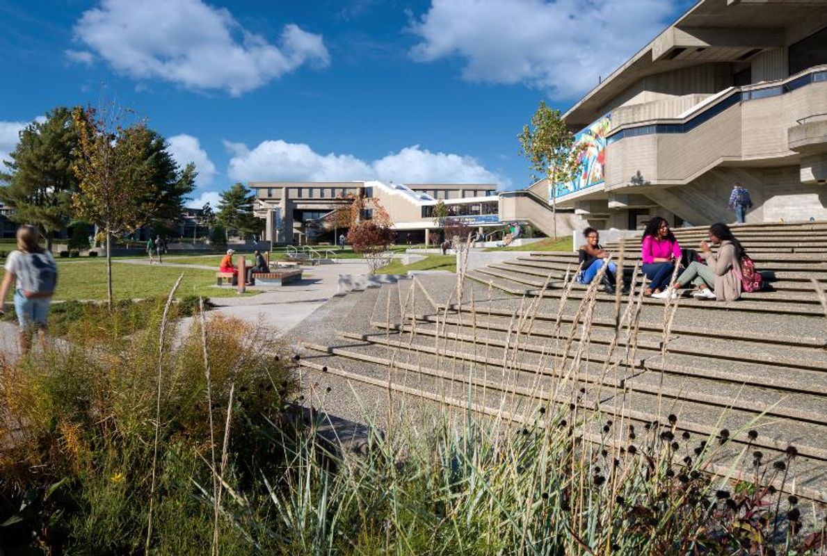 students sitting on steps at quad