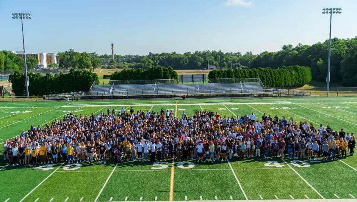 Class of 2026 posing on football field