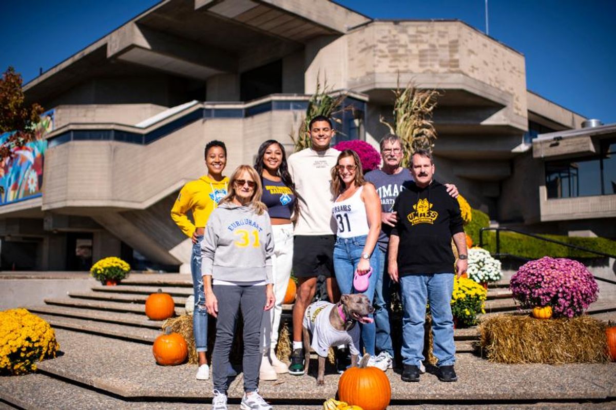 BGW Family posing on stairs with a dog