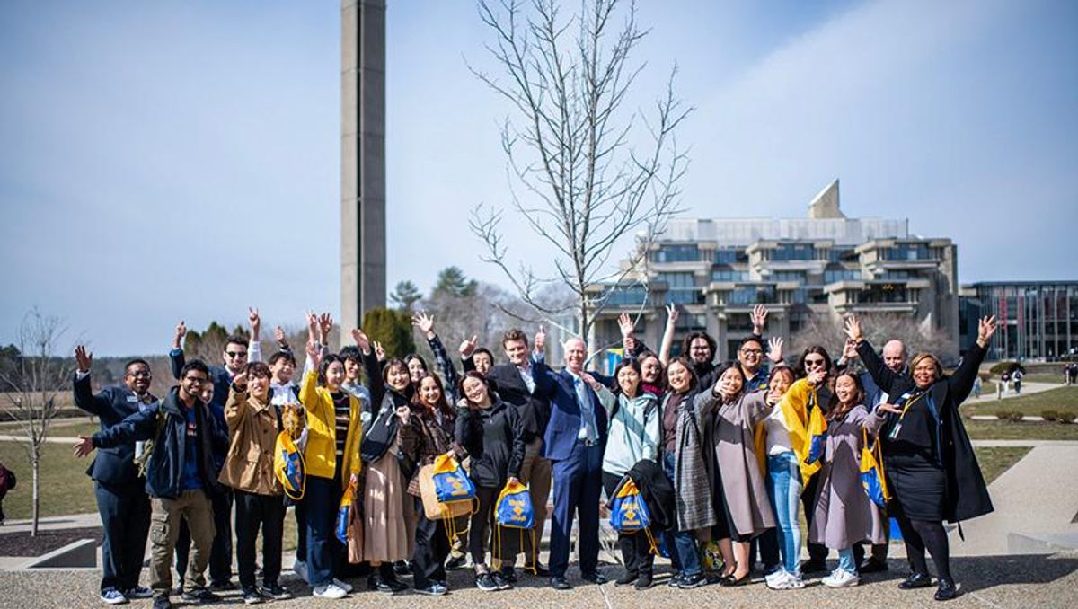 Model U.N. co-presidents Maxwell White and Nicole Kach, Chancellor Fuller, Vice Chancellor Kimberley Scott, and AVC Kevin Hamilton pose in the campus quad with 14 students from Japanese universities.