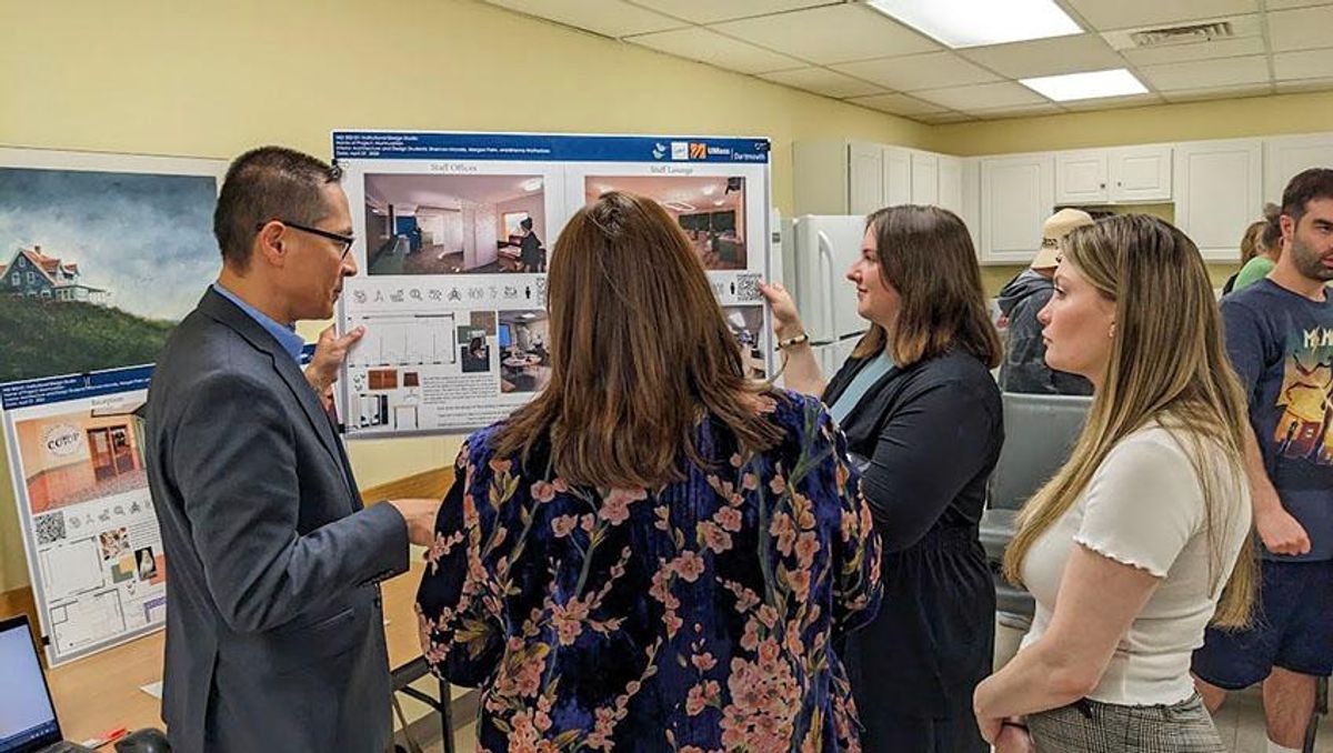 CO_OP President and C.E.O. Michael Cancilliere reviews designs with IAD students