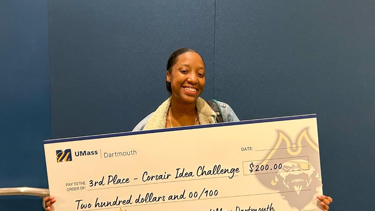 Jhania Johnson poses with her ceremonial third-place check