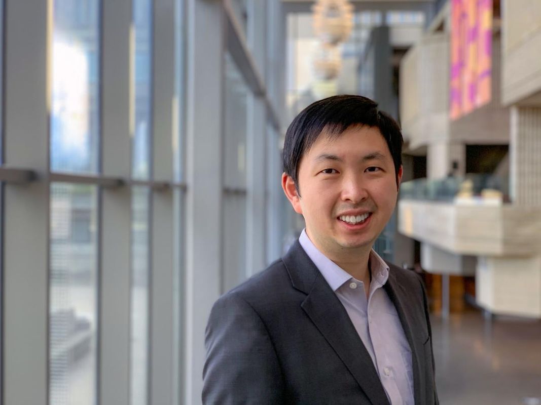 Computer science associate professor jiawei yuan in the library at umass dartmouth