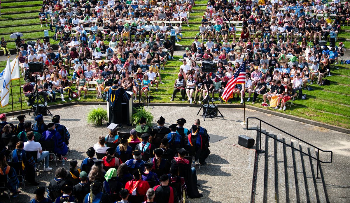 Students sitting in the crowd during Convocation Ceremony