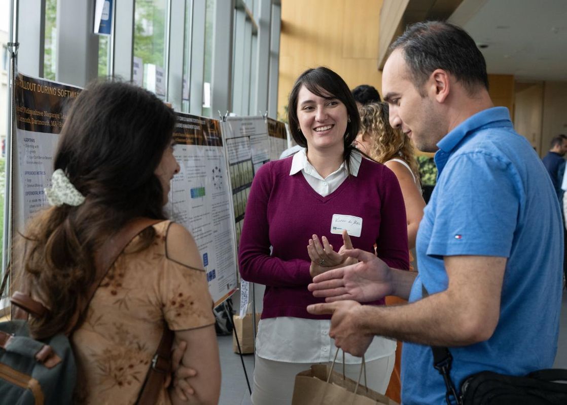 Students standing by posterboards showcasing research