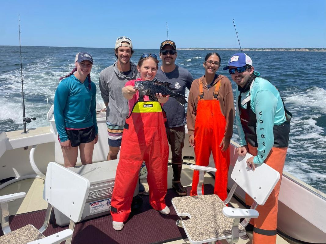 SMAST faculty and graduate students with New Bedford High School interns on a fish tagging trip