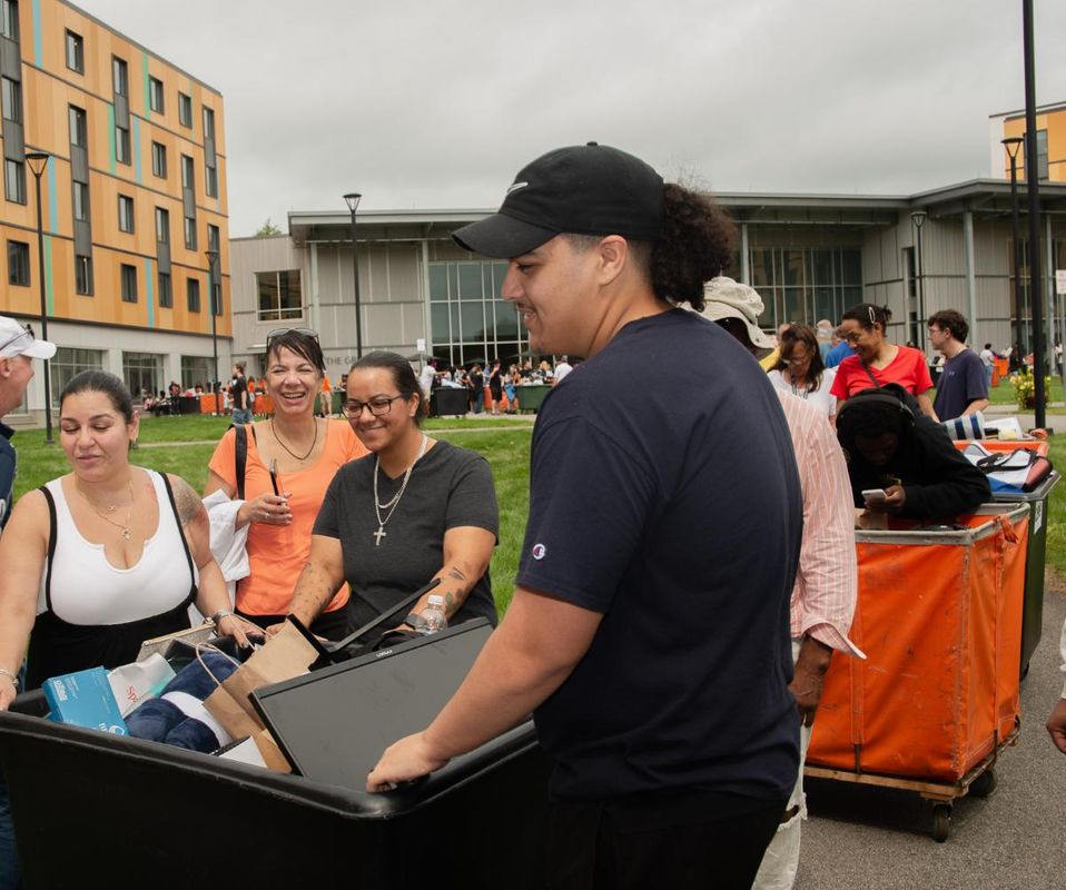 new student and family moving items into residence hall