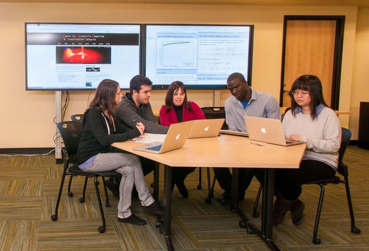 Professor and students sitting around table