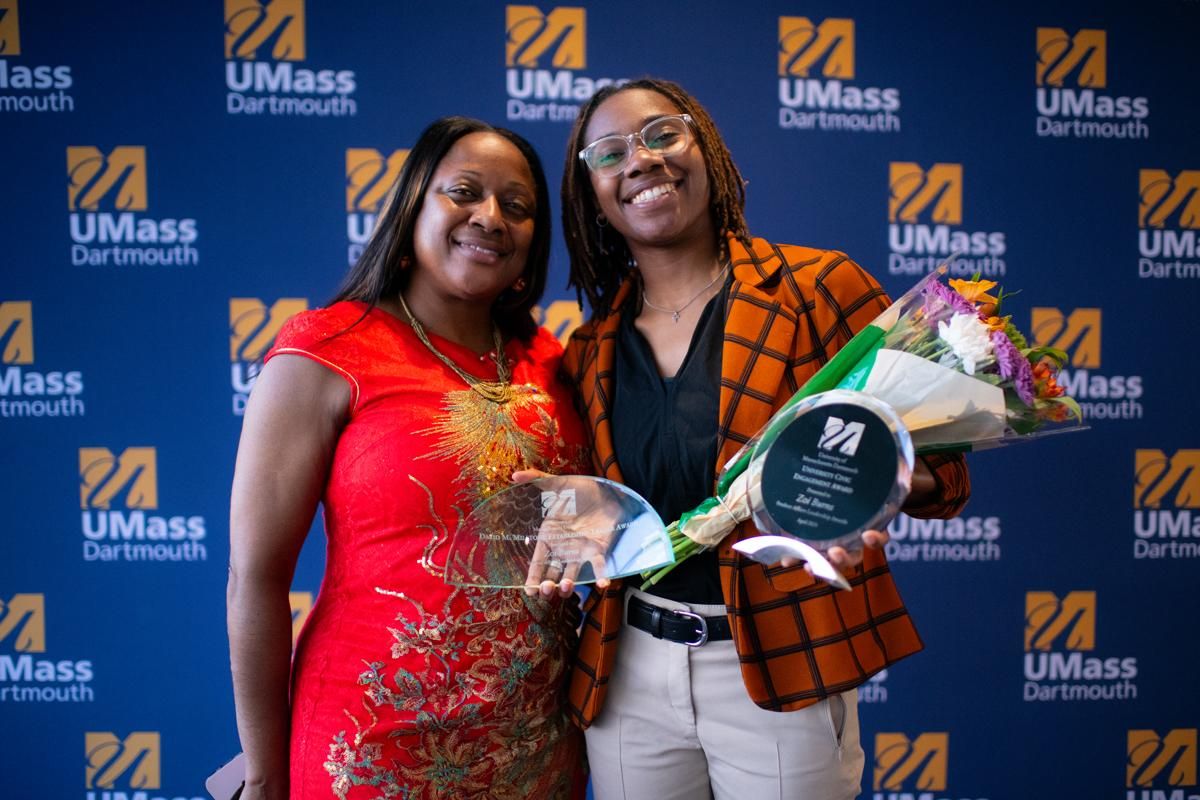 Student Zoi Burns posing with award