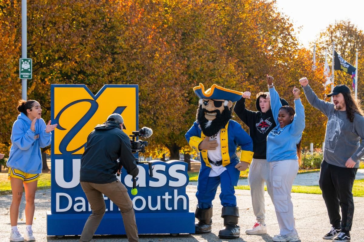 students pose for video