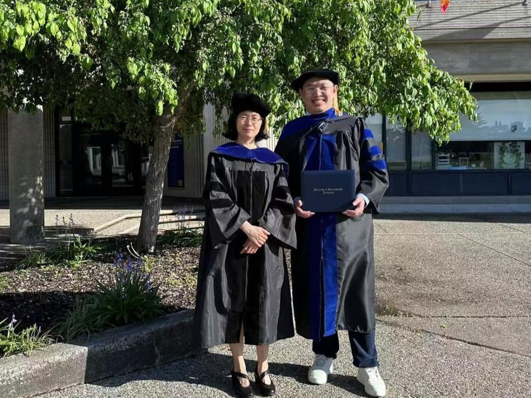 Liudong Xing with her PhD student Guixiang Lyu outside the 2025 PHD Commencement Ceremony