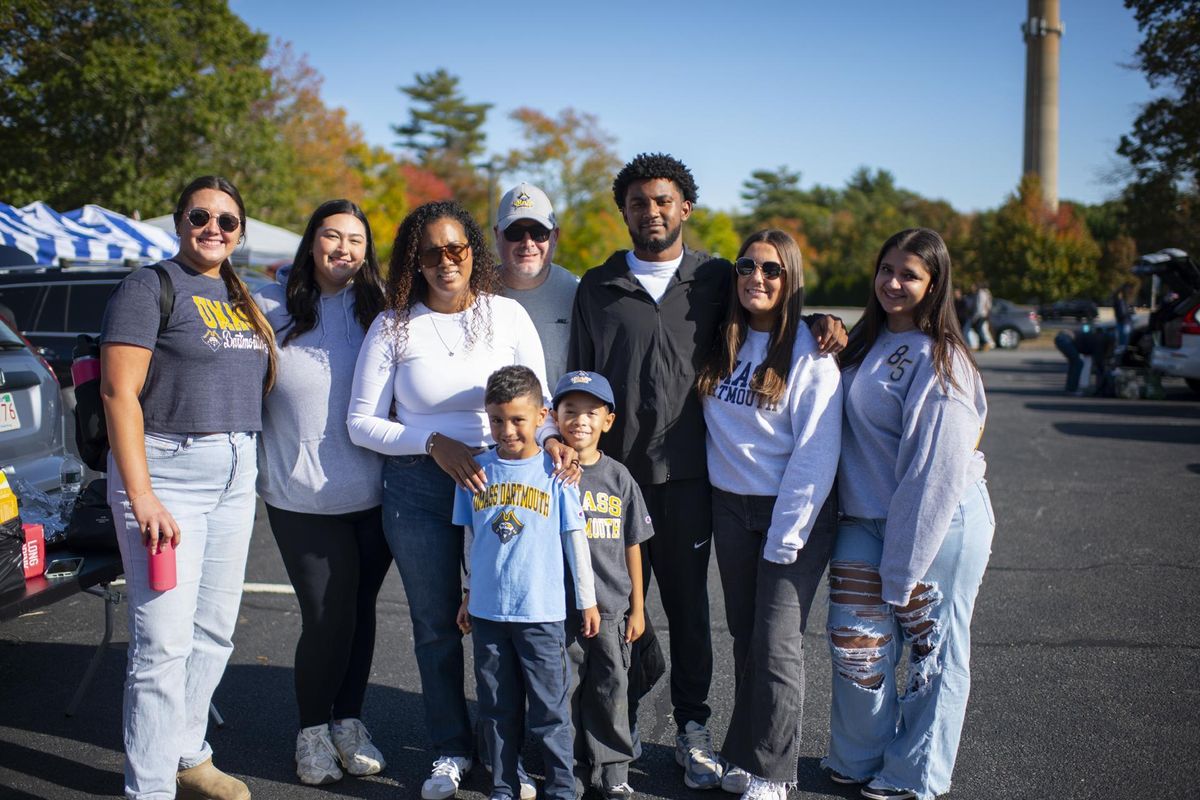 A family wearing UMass Dartmouth gear