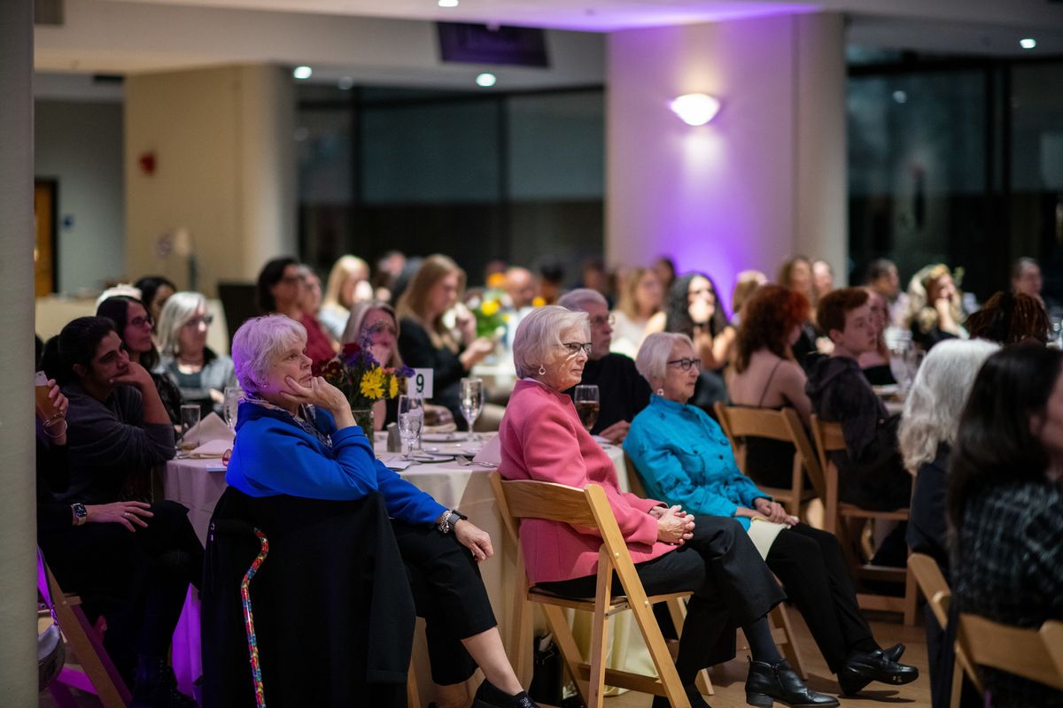 a seated crowd looks on during the CWGS 55 anniversary event