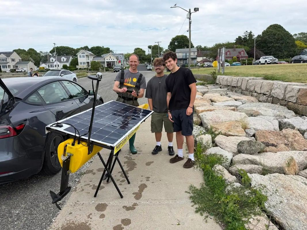Interns Matt Perez '27, electrical engineering, and Travis Wessman '28, computer science, with Andrew Gregg, founder of Sedna Robotics posed with marine robot