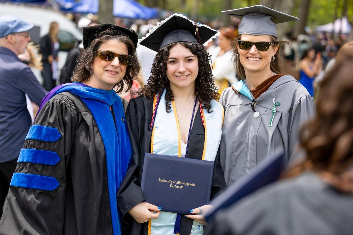 Botti-Salitsky (left) and McGoldrick (right) pictured with one of their students at the 2026 Commencement ceremony.