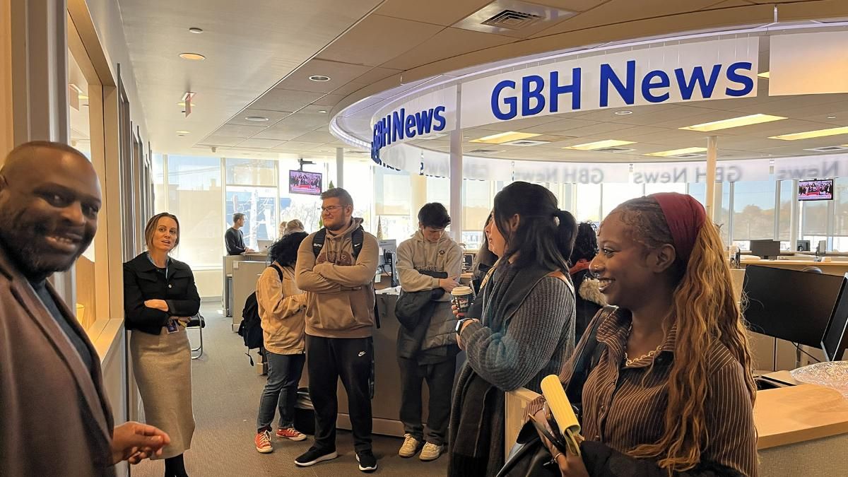UMD students talking to journalists in front of a GBH News sign