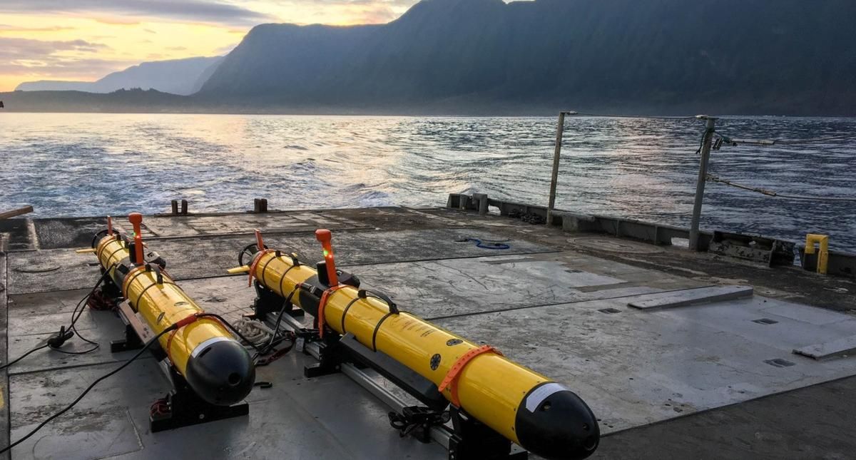 autonomous underwater vehicle resting on boat on water