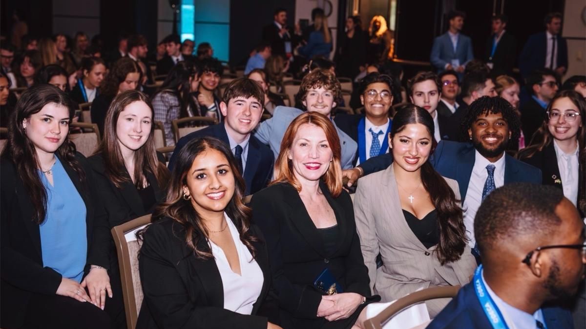 UMass Dartmouth Collegiate DECA members and advisors await award announcements at the International Career Development Conference (ICDC).