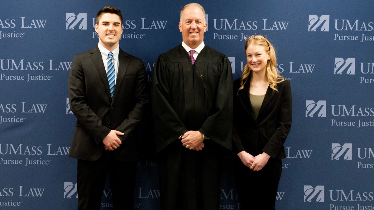UMass Law students Max Couture (left) and Sydney Brands (right) pictured with Hon. Joseph P. Harrington (center). Photo courtesy Kristina Besse