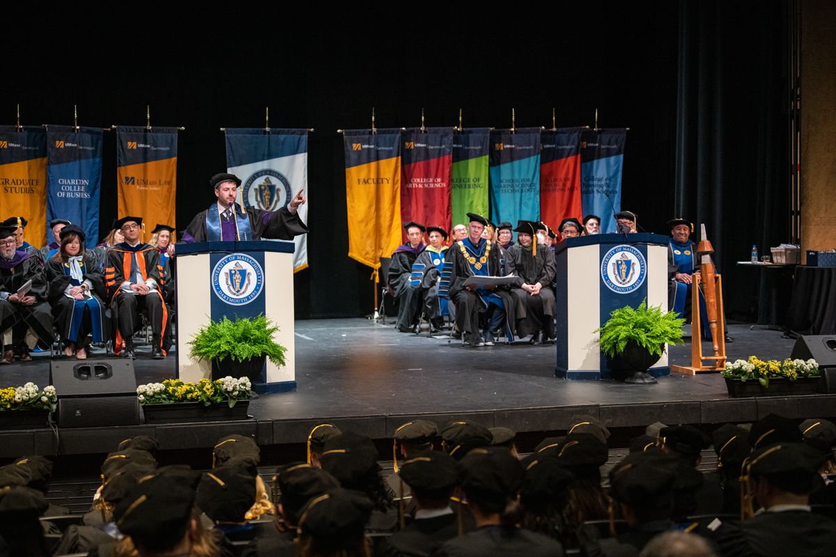 Standing at podium on stage