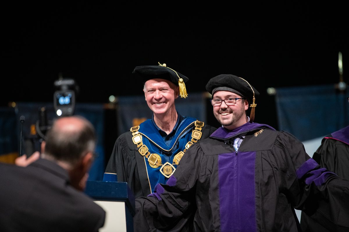 Student standing next to Chancellor Fuller