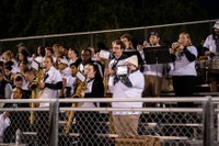 Students perform in the Pep Band during the football team's 