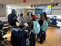 Students visiting tables at a career fair