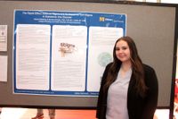 Nursing student with her research poster at the 2026 Scholarship Day