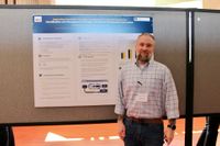 Nursing student with his research poster at the 2026 Scholarship Day