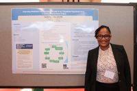Nursing student with her research poster at the 2026 Scholarship Day