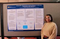Nursing student with her research poster at the 2026 Scholarship Day