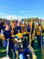 Colorguard members posed with mascot
