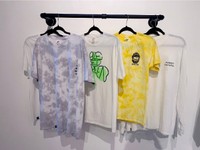 Wall Hanger, 2022, hanging exhibition t-shirts on mounted wall rack