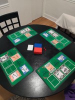 Out-Gunned Mat [View 3], (2023), top view of all four black neoprene mats at play with cards on their spots, 11 x 17 in.