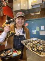 Rebecca McGee Tuck, Sculpture Monster artist in residence shows some of the thousands of bottle  caps that were drilled for the project