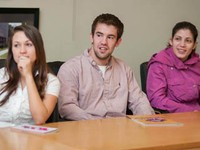 3 students at an Enactus weekly meeting in 2012